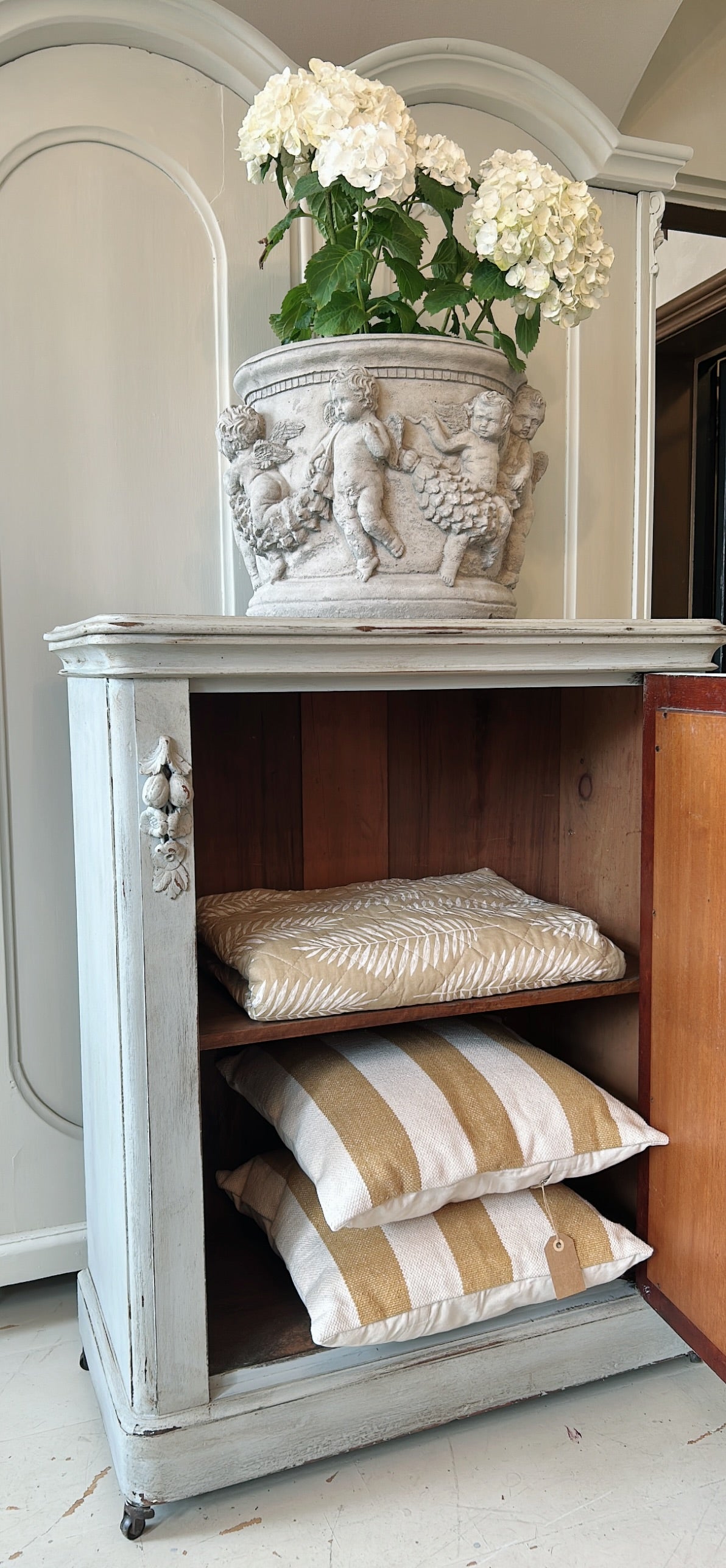 Petite antique cabinet with foxed mirrored door