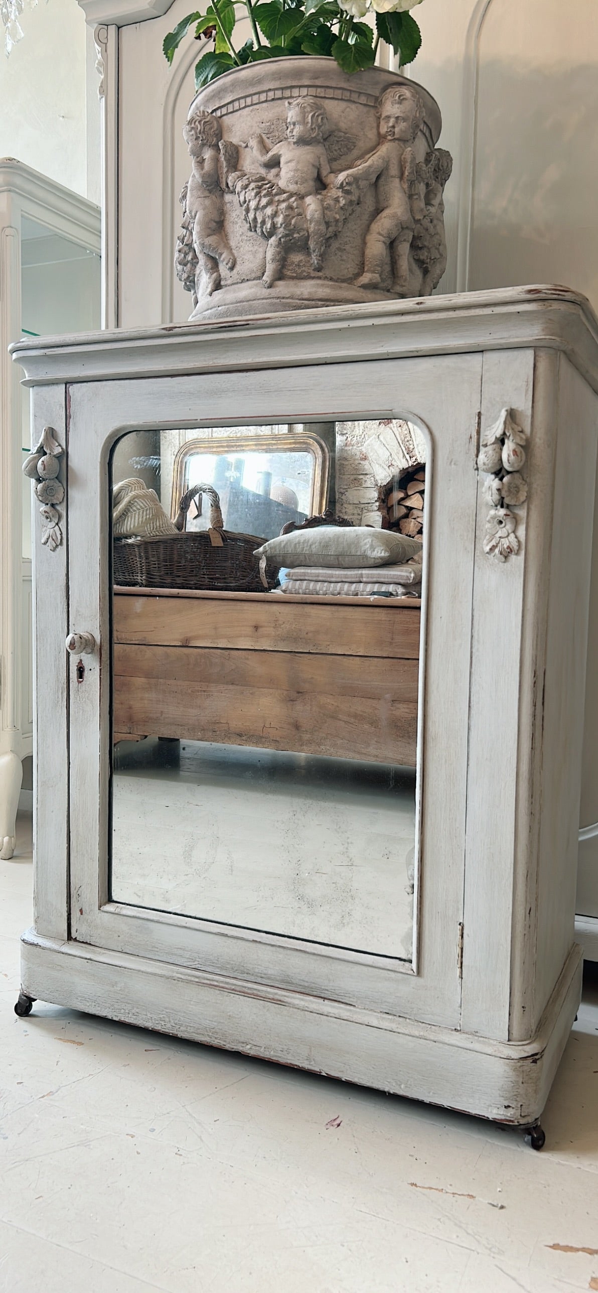 Petite antique cabinet with foxed mirrored door