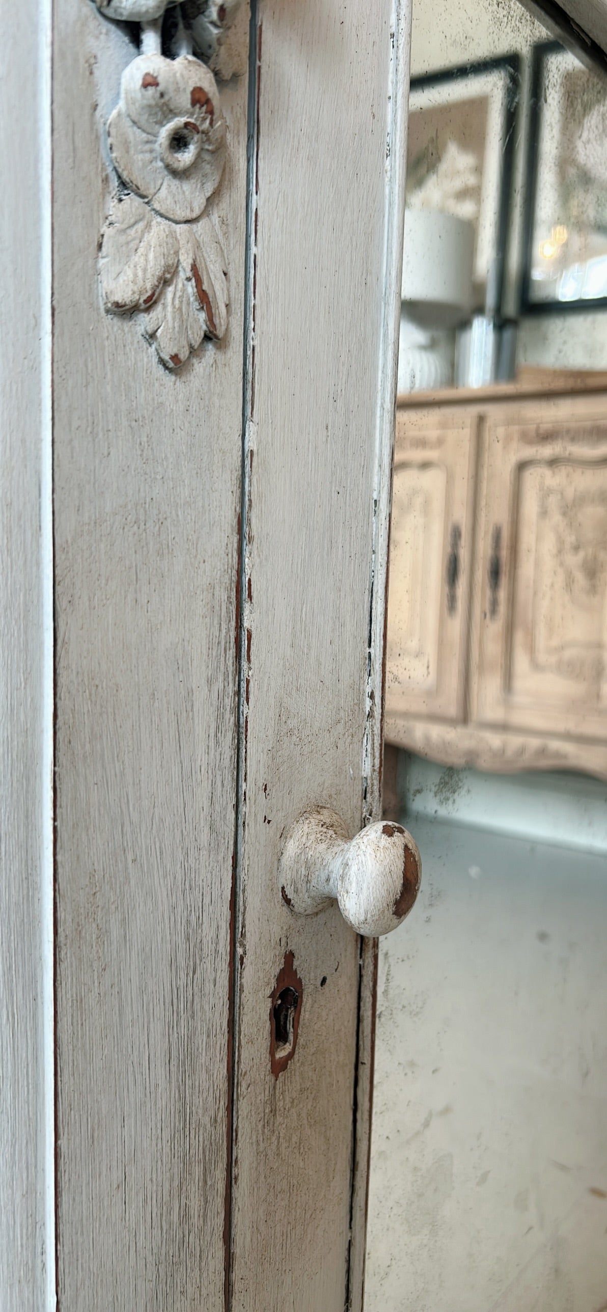 Petite antique cabinet with foxed mirrored door