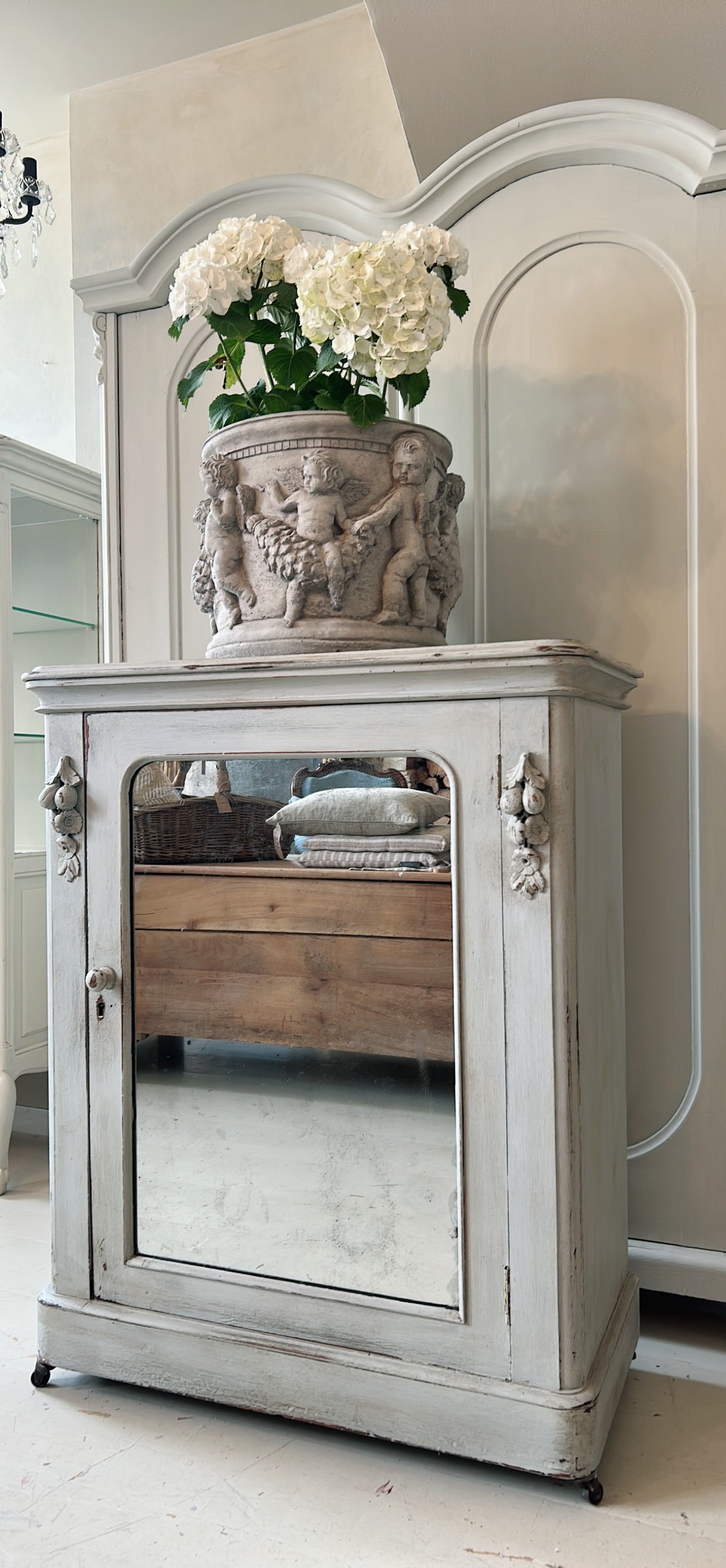 Petite antique cabinet with foxed mirrored door