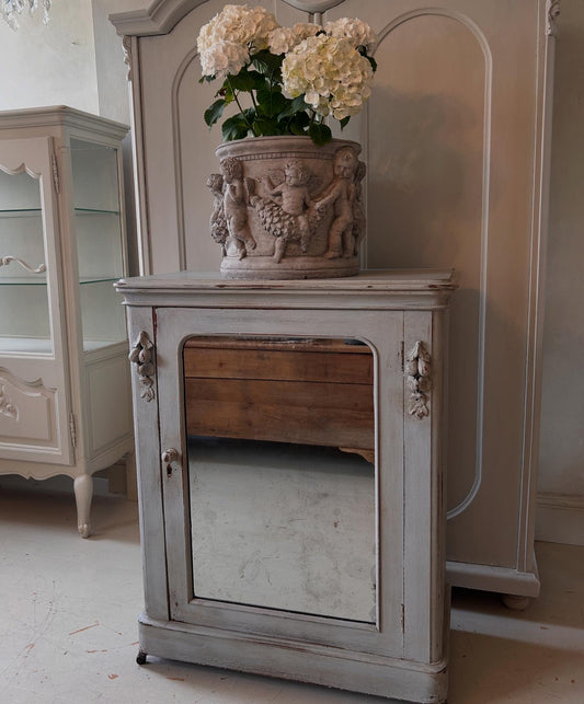 Petite antique cabinet with foxed mirrored door