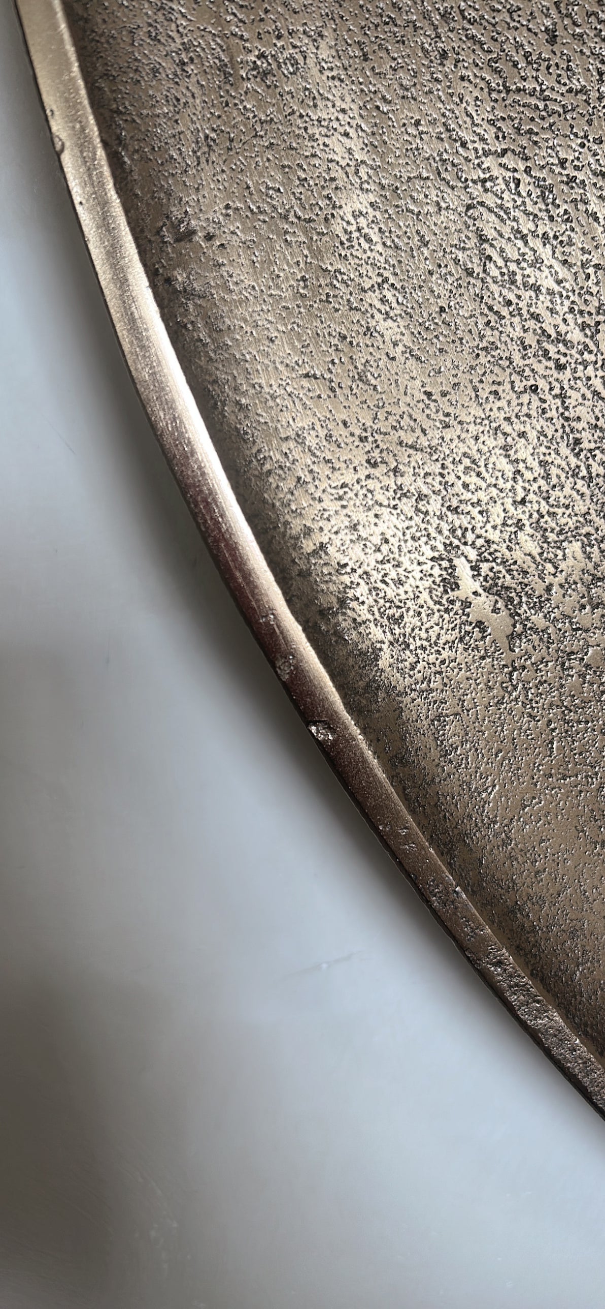Hammered gold round mirror